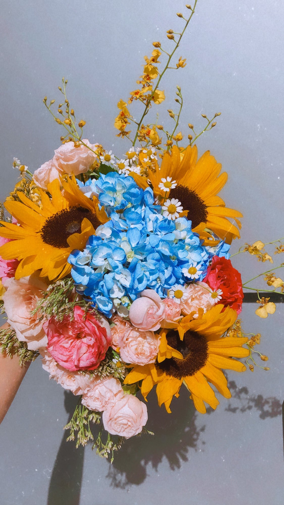 danciing lady orchids, sunflowers, hydrangeas and roses