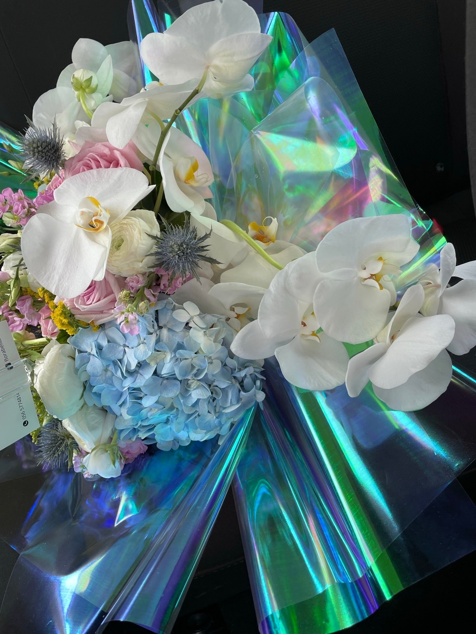 Orchids with blue hydrangea and fluorescent wrapping
