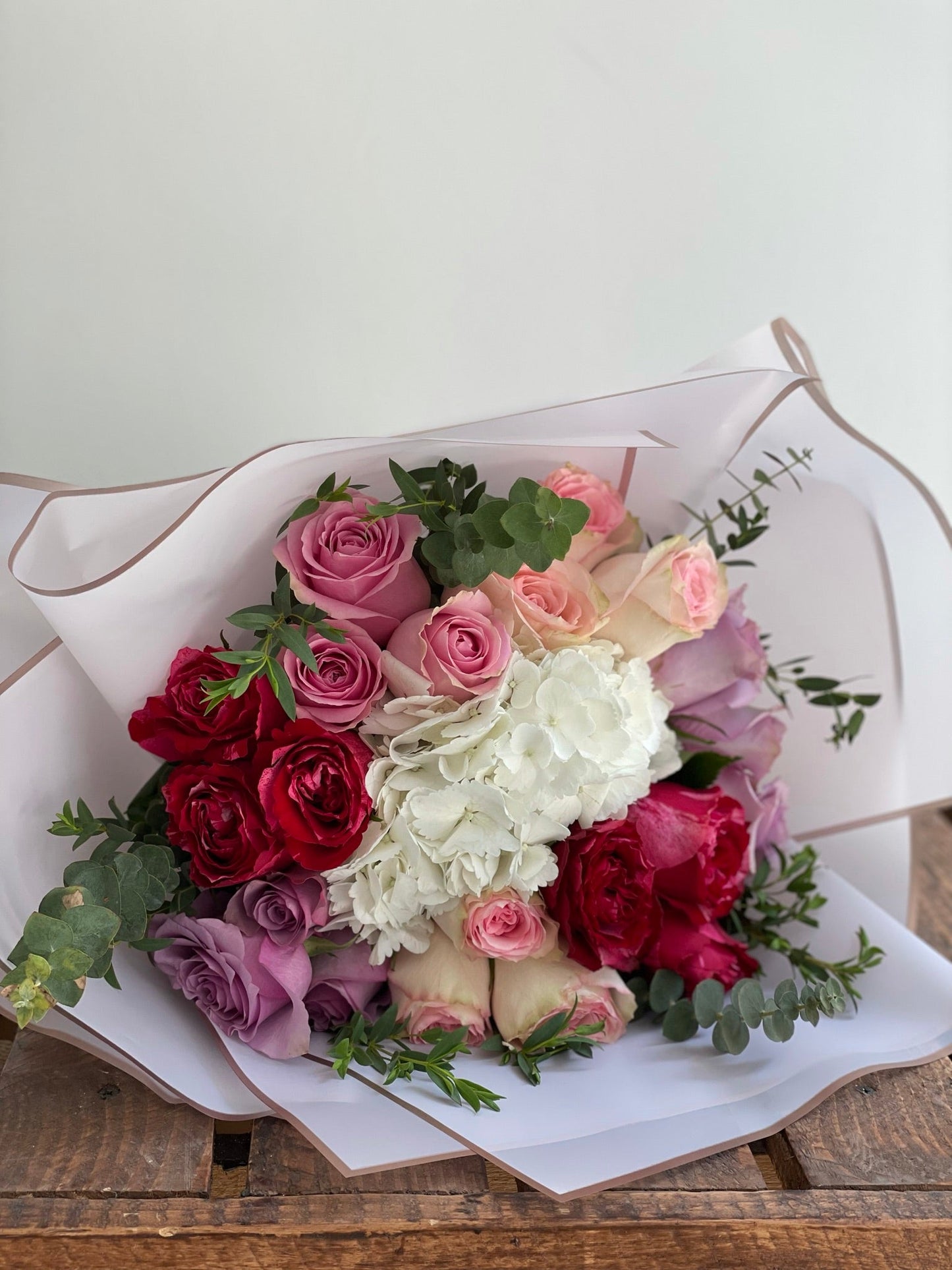 White hydrangea, with purple and pink roses