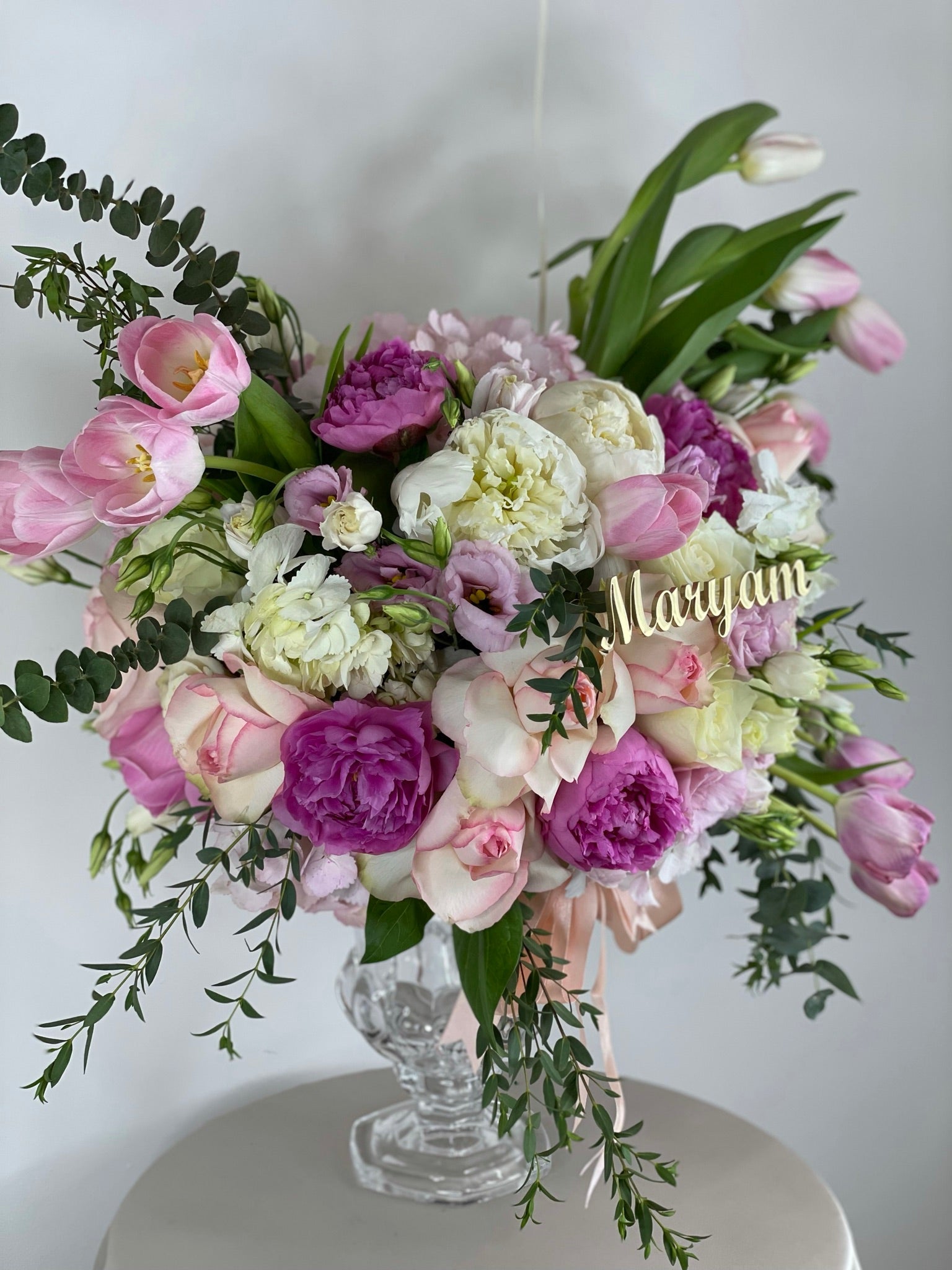 Mixed pink and white flowers in a vase with customized name