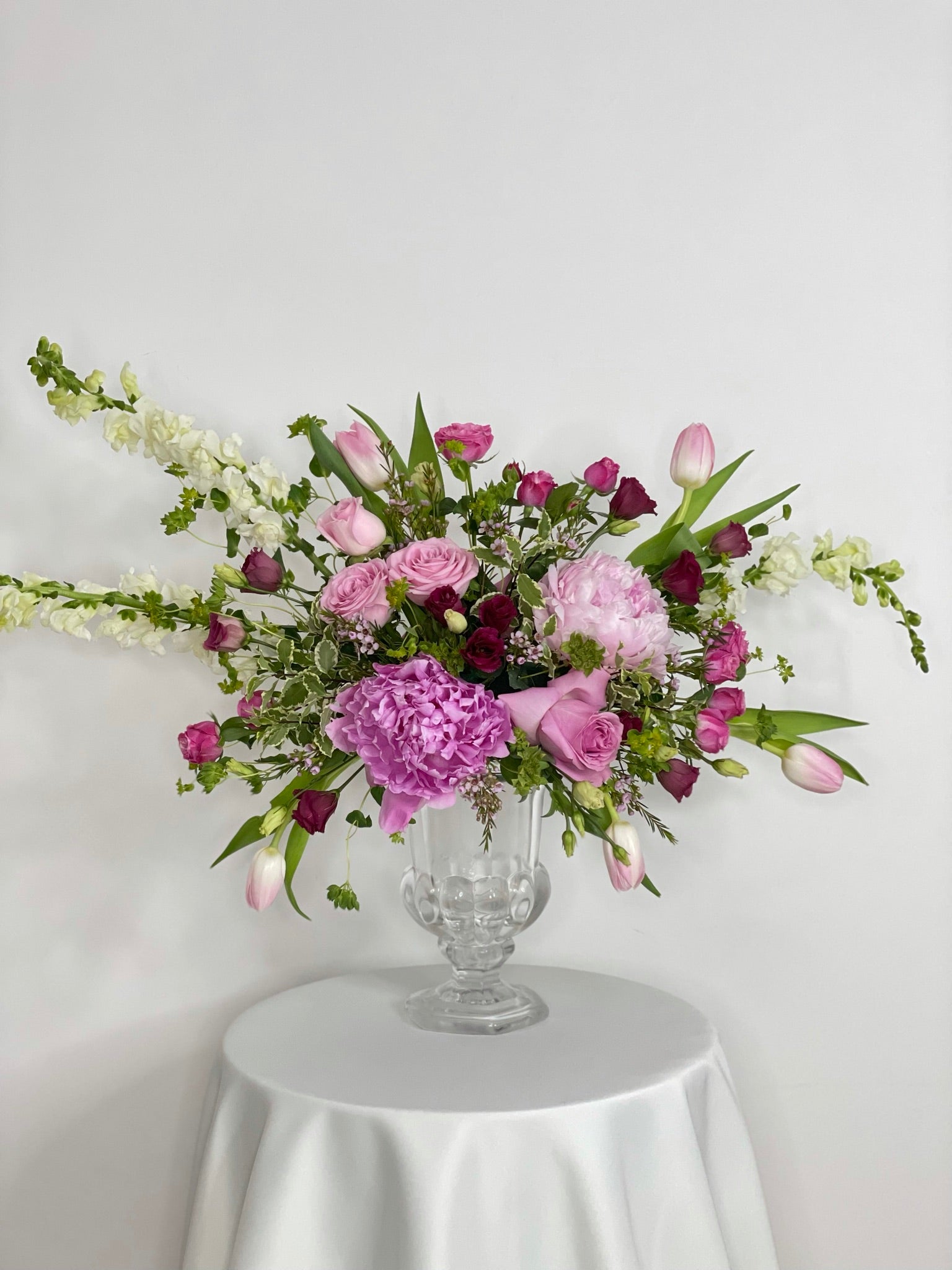 White delphinium with pink peonies