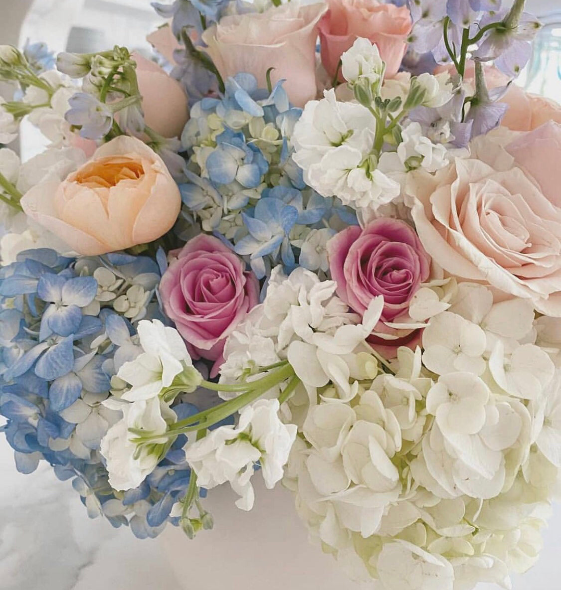 Soft coloured mixed floral arrangement