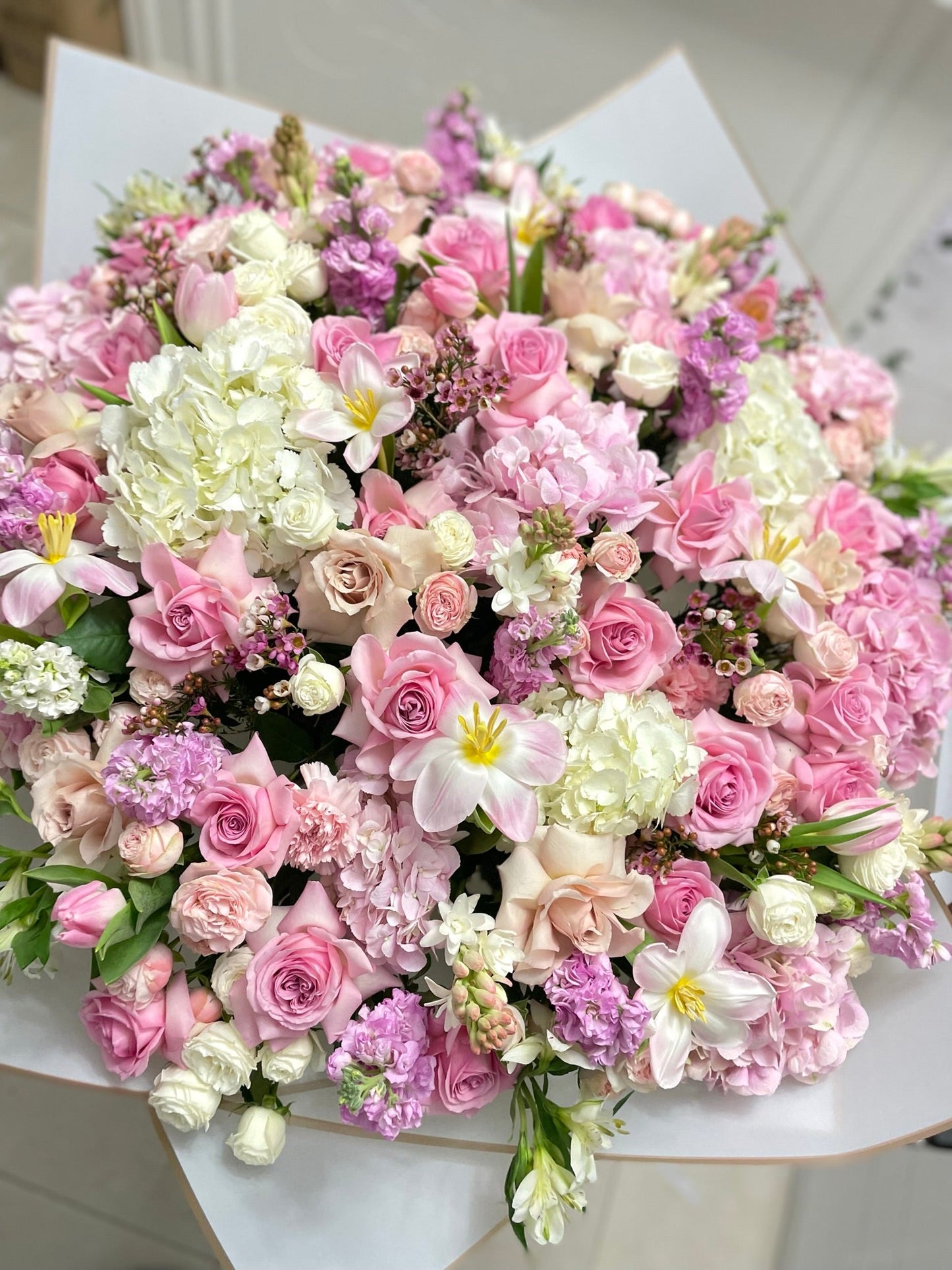 A jumbo sized bouquet of mixed pink flowers