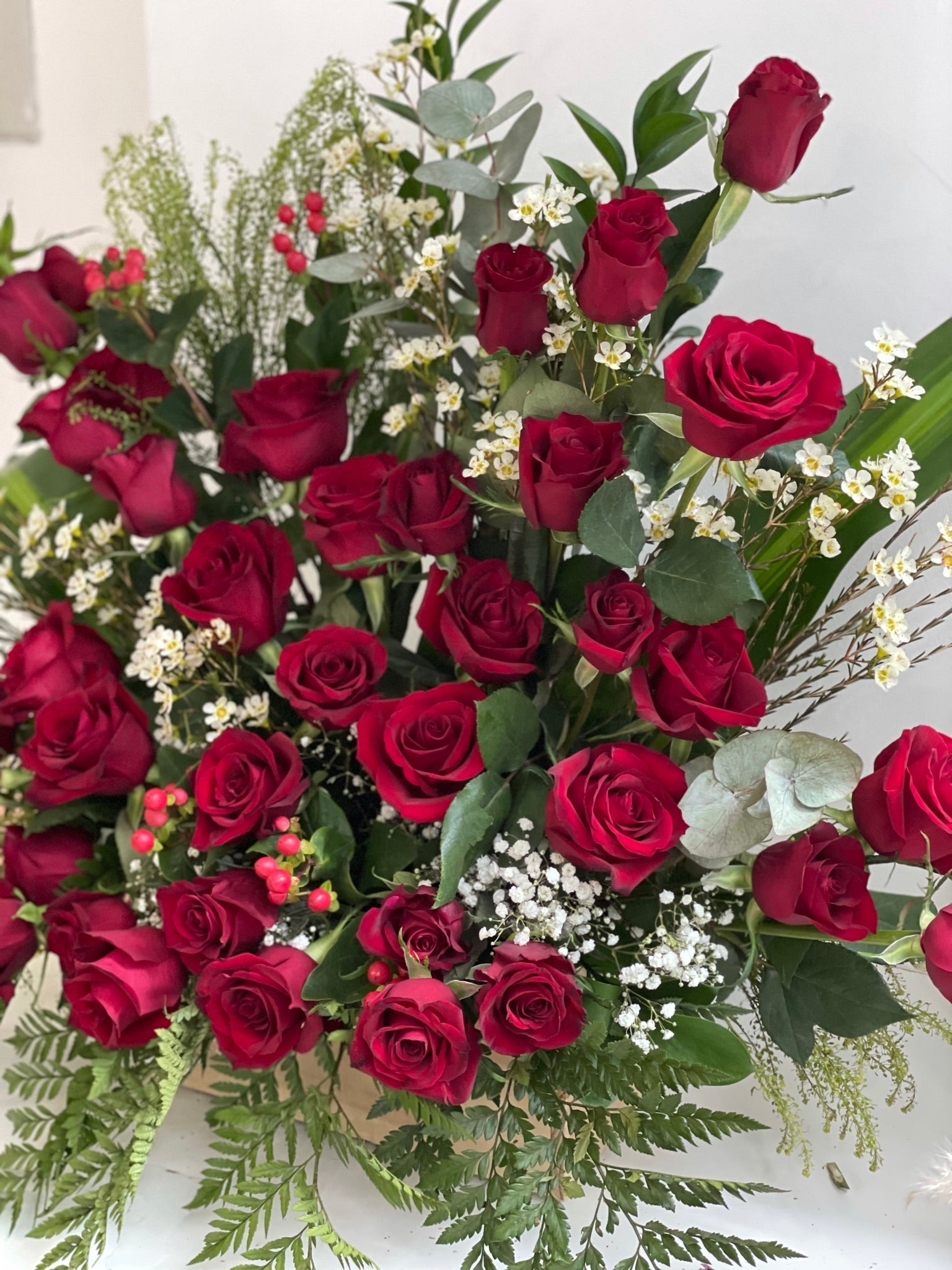 standing red rose floral arrangement
