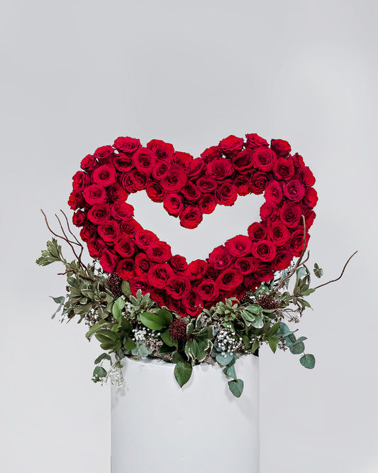 A stunning 3D heart-shaped arrangement standing tall, adorned with 80 gorgeous roses, a striking display of love for Valentine's Day.