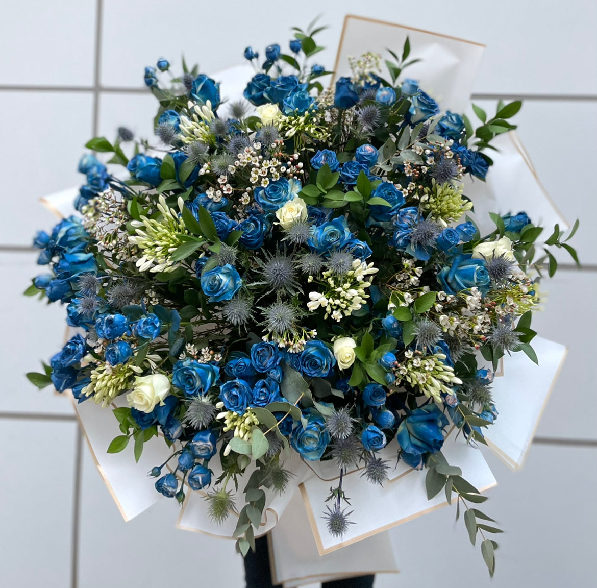 A giant bouquet of blue ross with greenery
